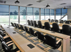Solar shades providing UV protection in a conference room.