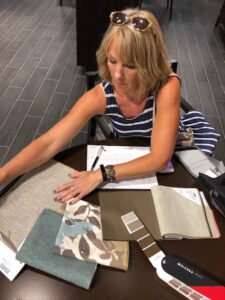 A design professional assisting in the window covering selection process.